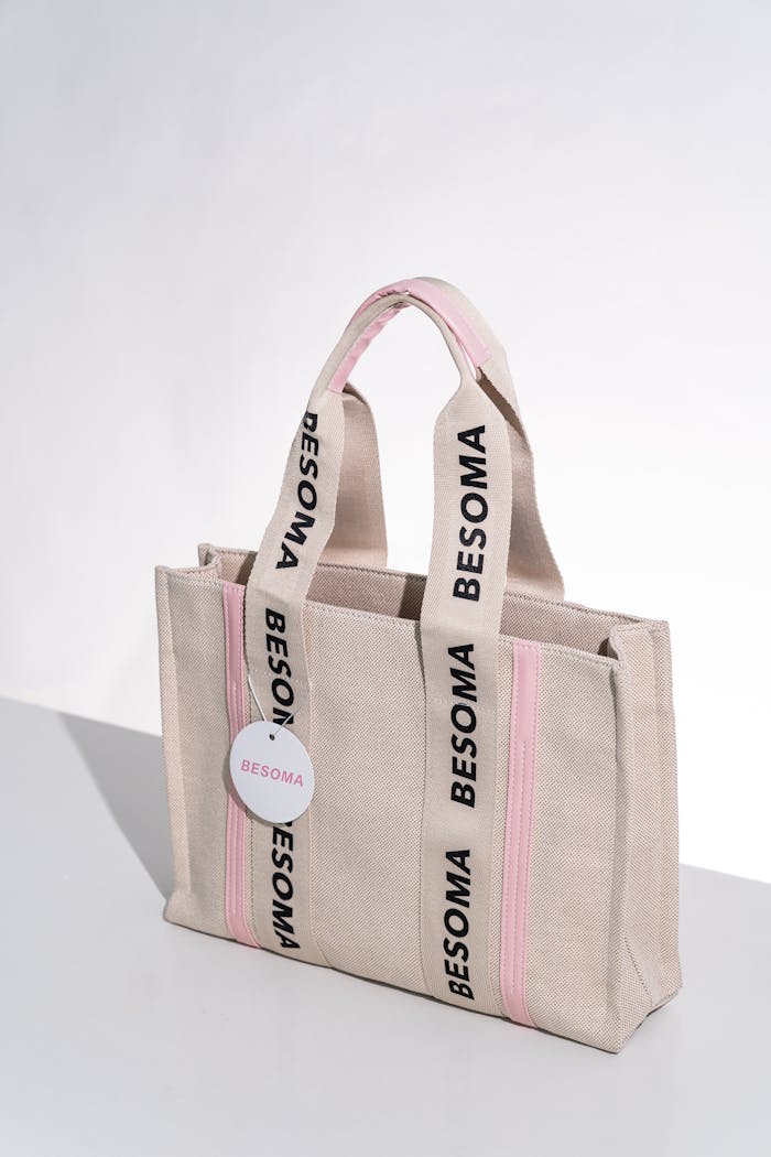 services-06 Chic Besoma tote bag with pink accents on a white backdrop, perfect for fashion shoots.